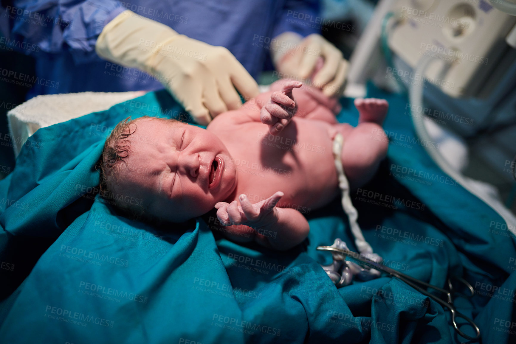 Buy stock photo Shot of a newly born baby girl surrounded by medical staff in the hospital