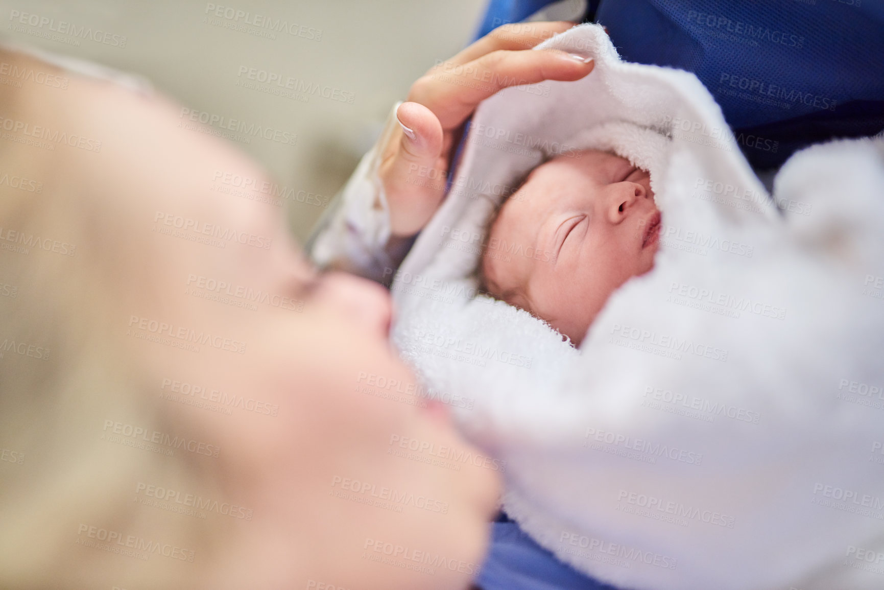 Buy stock photo Shot of an adorable baby girl sleeping in her mother's arms in hospital