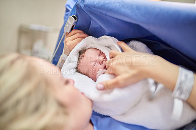 Buy stock photo Shot of an adorable baby girl sleeping in her mother's arms in hospital