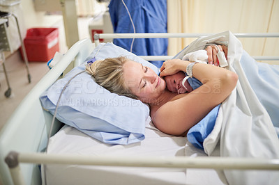 Buy stock photo Shot of a beautiful young mother lying in bed with her newly born baby girl in the hospital