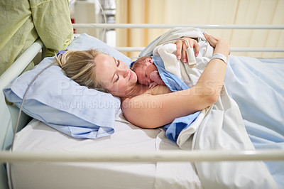 Buy stock photo Shot of a beautiful young mother lying in bed with her newly born baby girl in the hospital