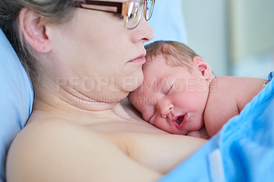 Buy stock photo Shot of an adorable newly born baby girl sleeping on her mother's chest at the hospital