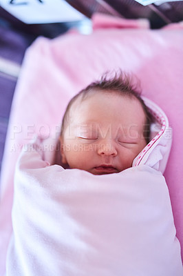 Buy stock photo Shot of a newly born baby girl wrapped in a blanket in the hospital