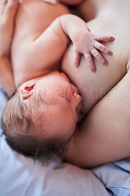 Buy stock photo Shot of unrecognizable woman breastfeeding her newborn daughter in hospital