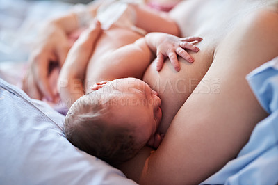 Buy stock photo Shot of unrecognizable woman breastfeeding her newborn daughter in hospital