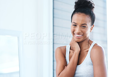 Buy stock photo Shot of a beautiful young woman standing in the bathroom at home