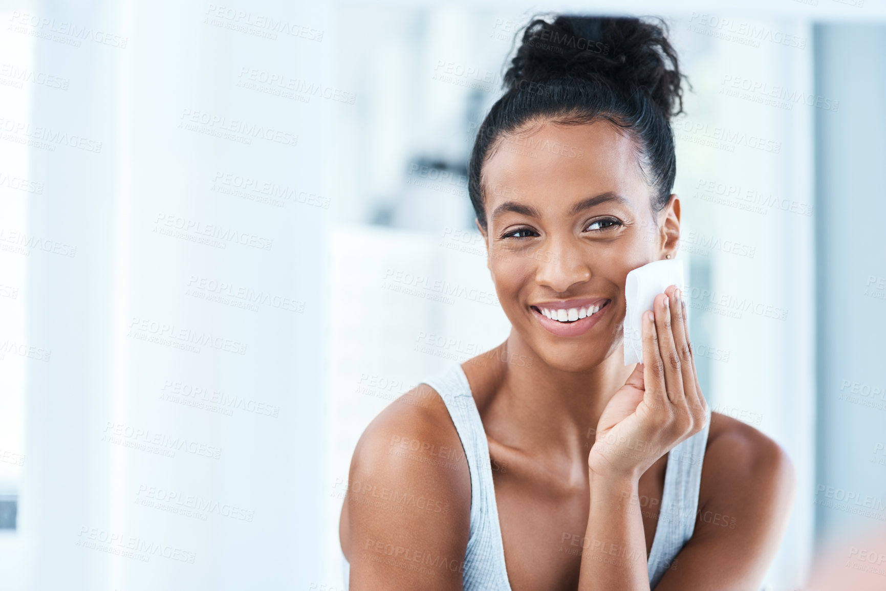 Buy stock photo Skincare, black woman with cotton pad on face and smile, makeup cleaning and luxury skin product in bathroom. Dermatology, cosmetics and beauty facial, African model with cleansing pads and mock up.