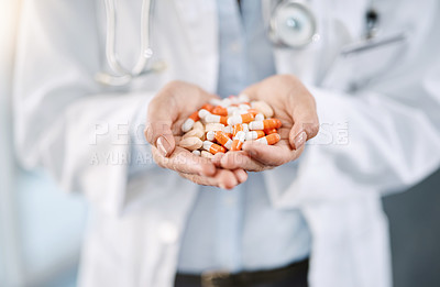 Buy stock photo Closeup shot of an unidentifiable doctor holding a variety of pills in her hands