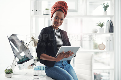 Buy stock photo Cropped portrait of an attractive young businesswoman working on her digital tablet in the office