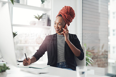 Buy stock photo Cropped shot of an attractive young businesswoman taking notes while making a phonecall at her desk in the office