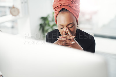 Buy stock photo Cropped shot of an attractive young businesswoman suffering with a headache while sitting at her desk in the office