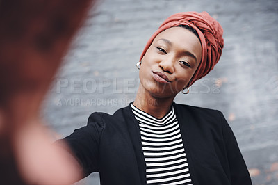 Buy stock photo Cropped portrait of an attractive young businesswoman taking selfies against a grey brick wall