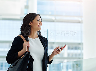 Buy stock photo Cropped shot of an attractive young businesswoman looking thoughtful while holding a smartphone in a modern office