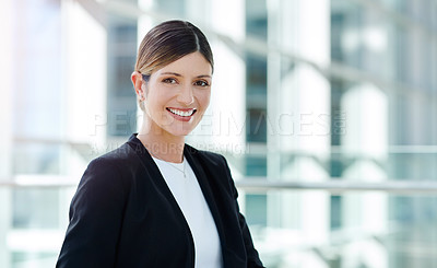Buy stock photo Cropped portrait of an attractive young businesswoman smiling while sitting in a modern office