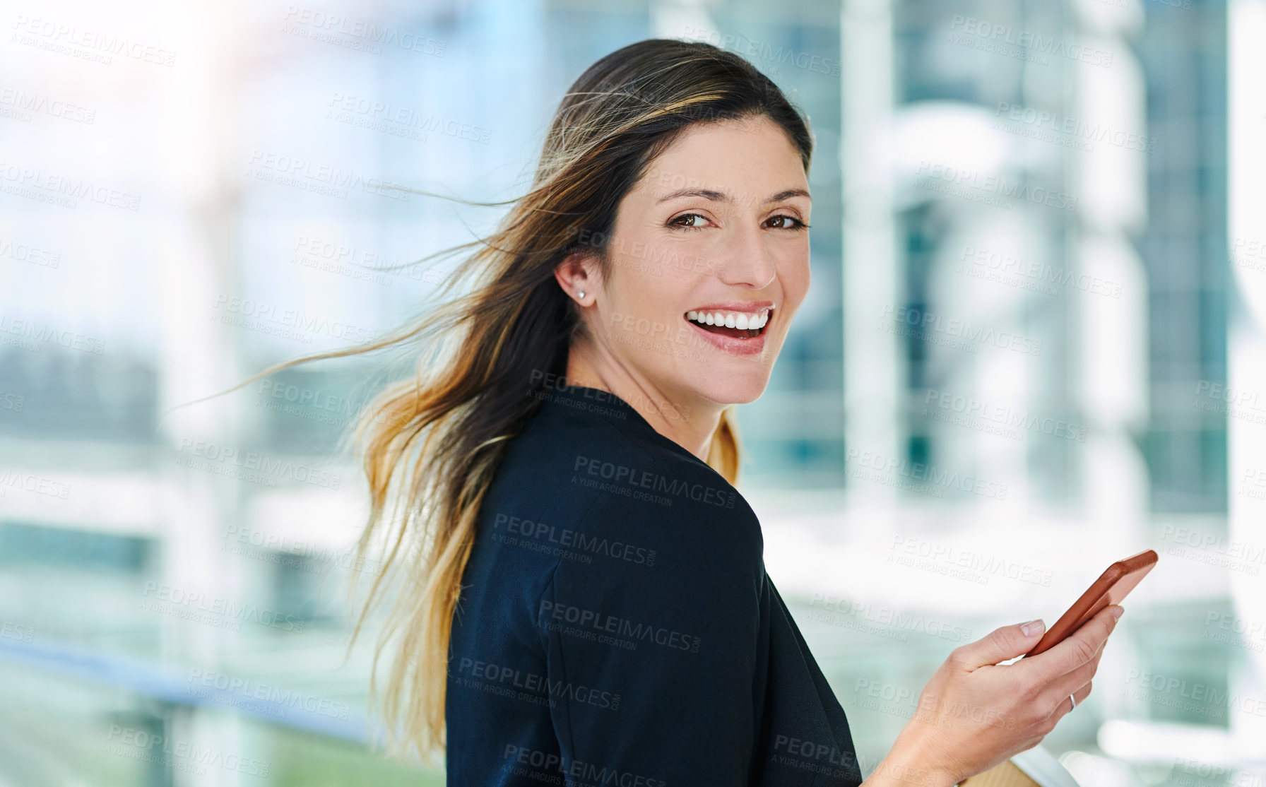 Buy stock photo Cropped portrait of an attractive young businesswoman smiling while walking through a modern office