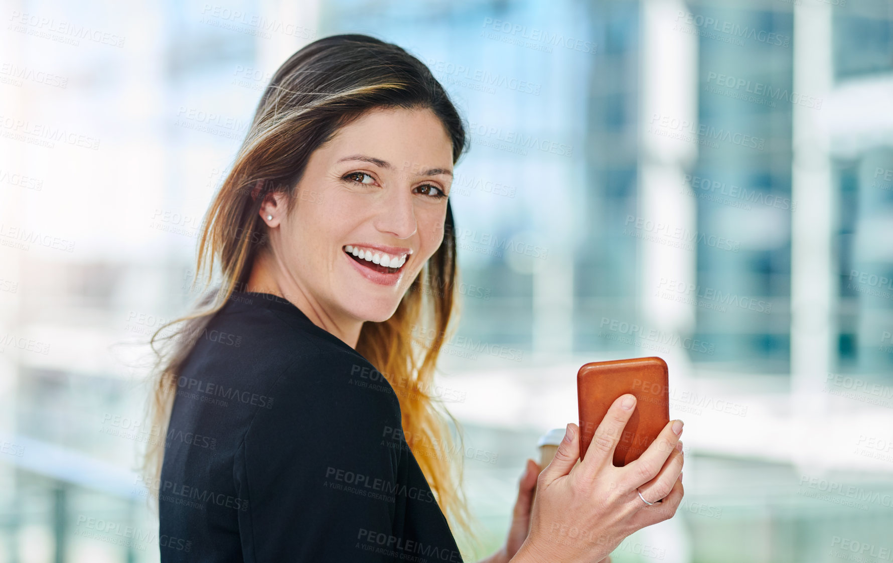 Buy stock photo Cropped portrait of an attractive young businesswoman smiling while walking through a modern office