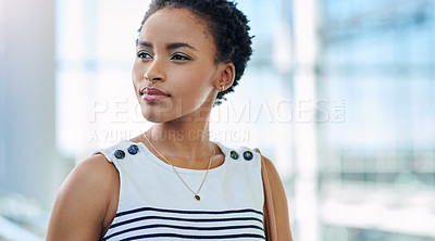 Buy stock photo Cropped shot of an attractive young businesswoman looking thoughtful while standing in a modern office