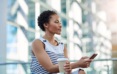 Buy stock photo Cropped shot of an attractive young businesswoman looking thoughtful while using a smartphone in a modern office