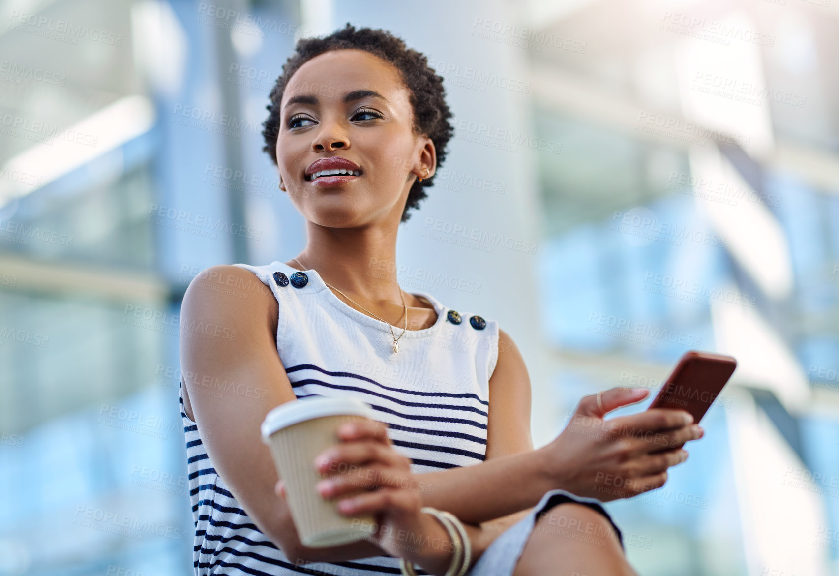 Buy stock photo Cropped shot of an attractive young businesswoman looking thoughtful while using a smartphone in a modern office