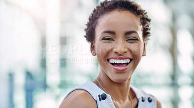 Buy stock photo Cropped portrait of an attractive young businesswoman smiling while sitting in a modern workplace