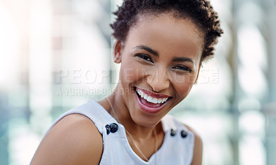 Buy stock photo Cropped portrait of an attractive young businesswoman laughing while sitting in a modern workplace