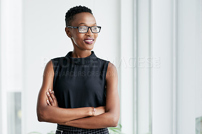 Buy stock photo Shot of a confident young businesswoman working in a modern office