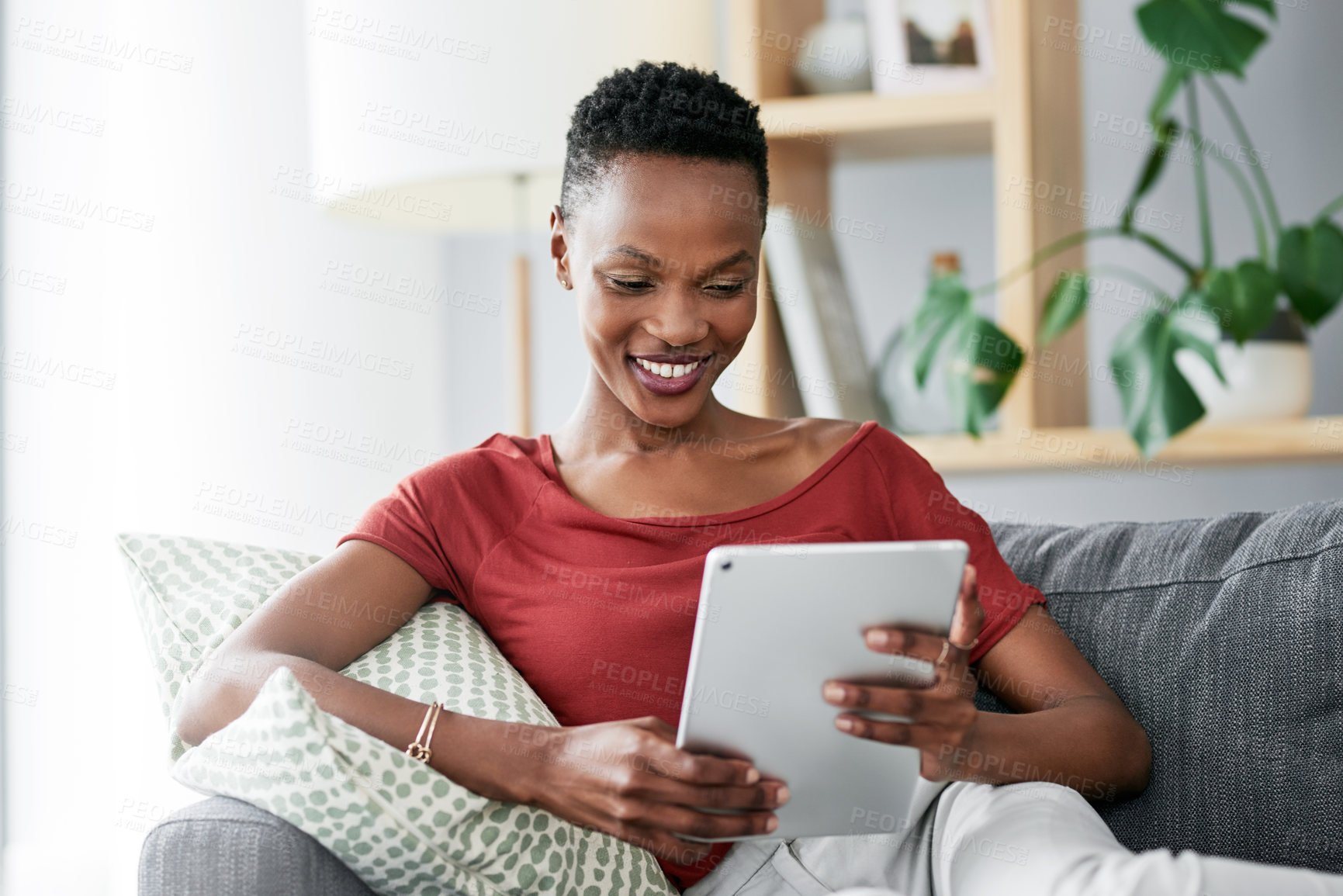 Buy stock photo Digital tablet, relax and happy black woman on a sofa for social media, reading and browsing blog in her home. Smile, online and African female person on couch with ebook, streaming or subscription 