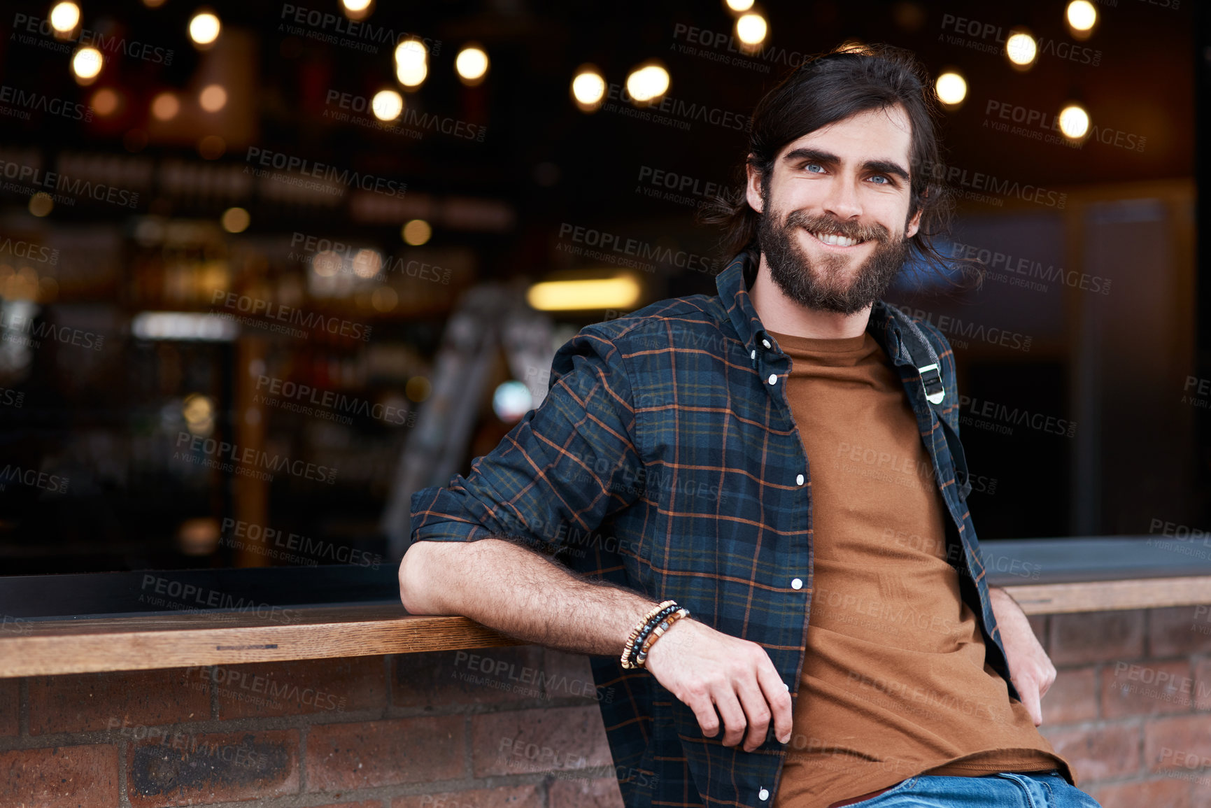 Buy stock photo Portrait of a handsome young man posing outside a cafe in the city
