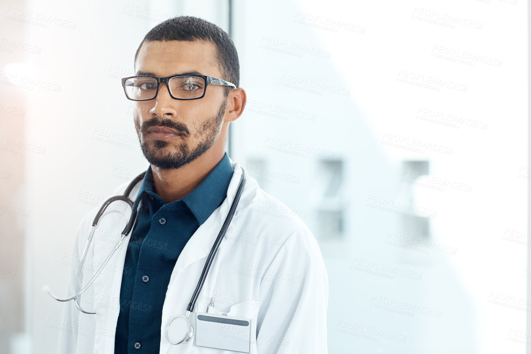 Buy stock photo Portrait of a confident young doctor working in a modern hospital