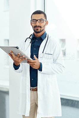 Buy stock photo Portrait of a young doctor using a digital tablet in a modern hospital