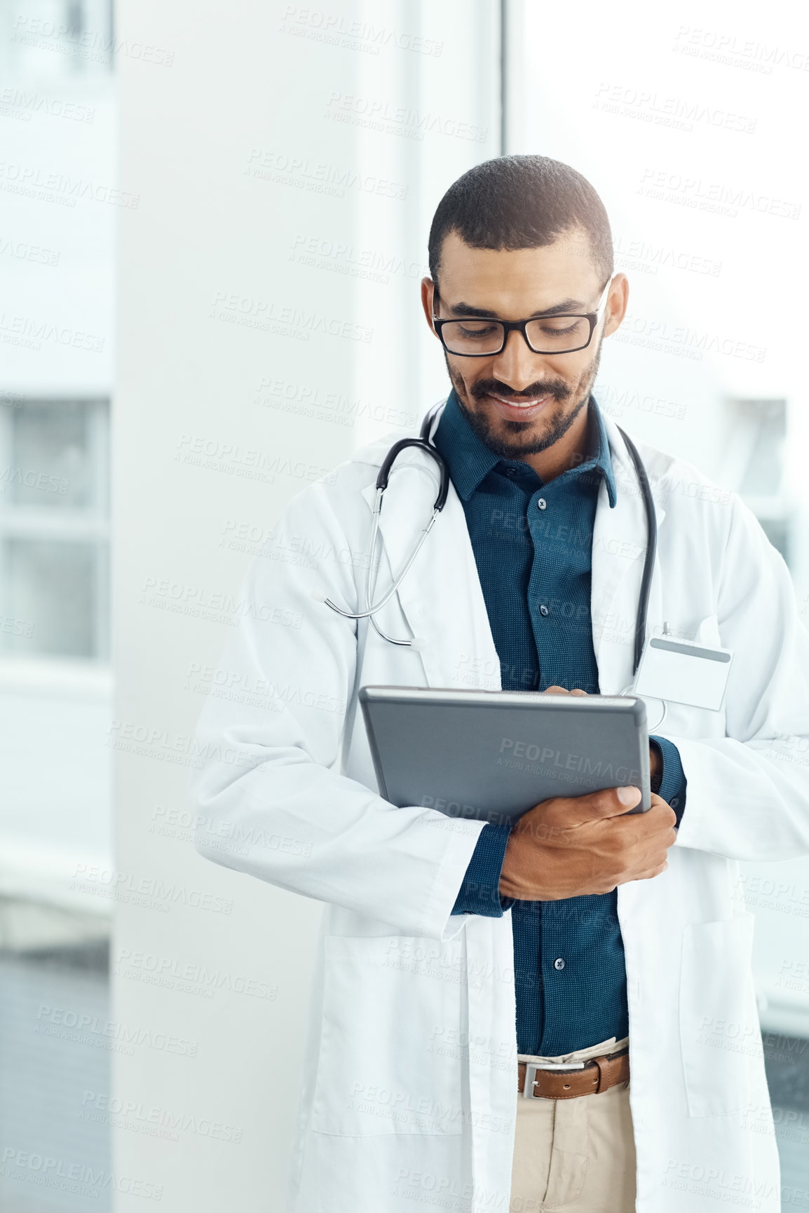 Buy stock photo Tablet, smile and doctor in hospital with research for medical support online with career. Man, digital technology and male surgeon with patient history in website for healthcare service in clinic.