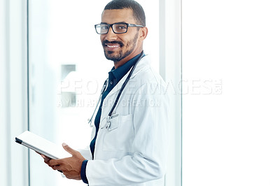 Buy stock photo Portrait of a young doctor using a digital tablet in a modern hospital