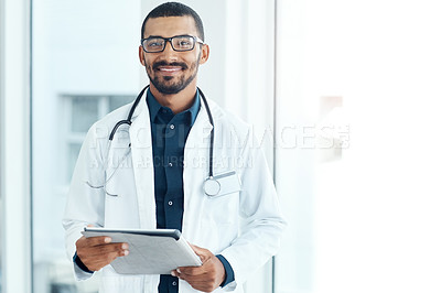 Buy stock photo Portrait of a young doctor using a digital tablet in a modern hospital