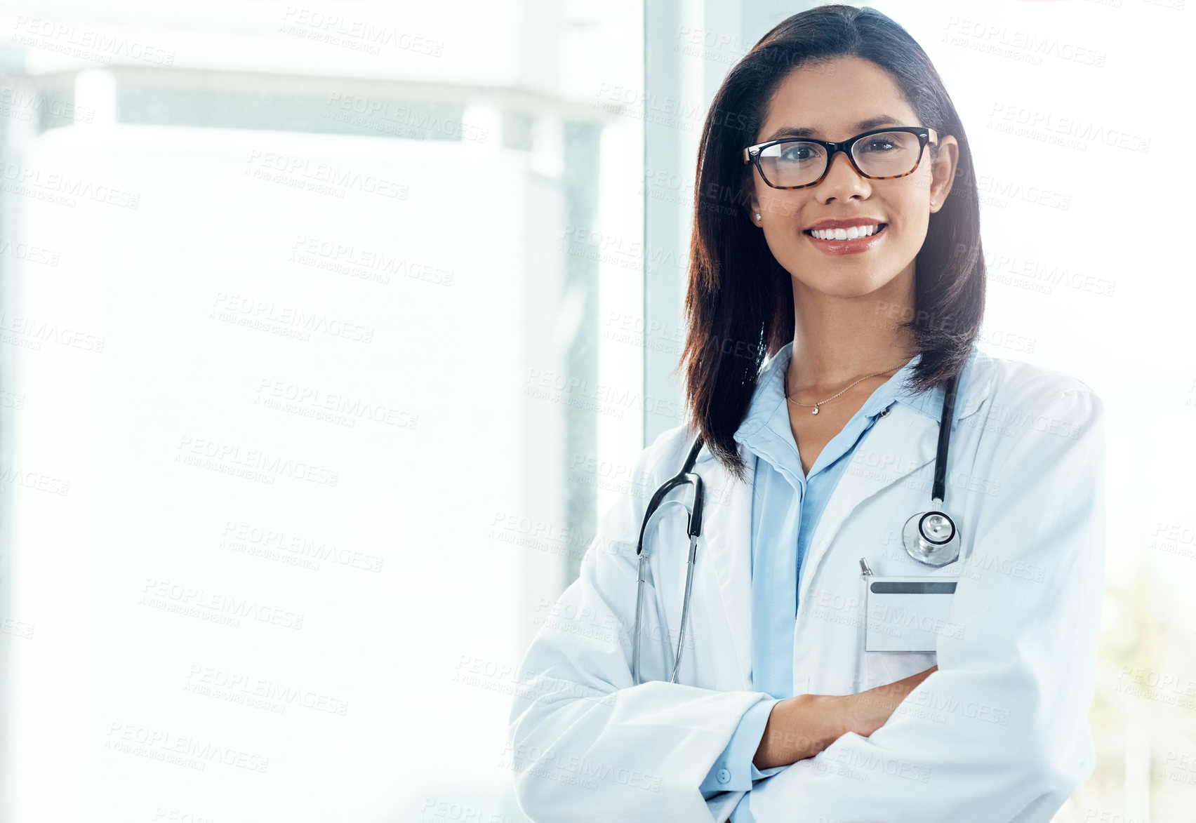 Buy stock photo Portrait of a confident young doctor working in a modern hospital