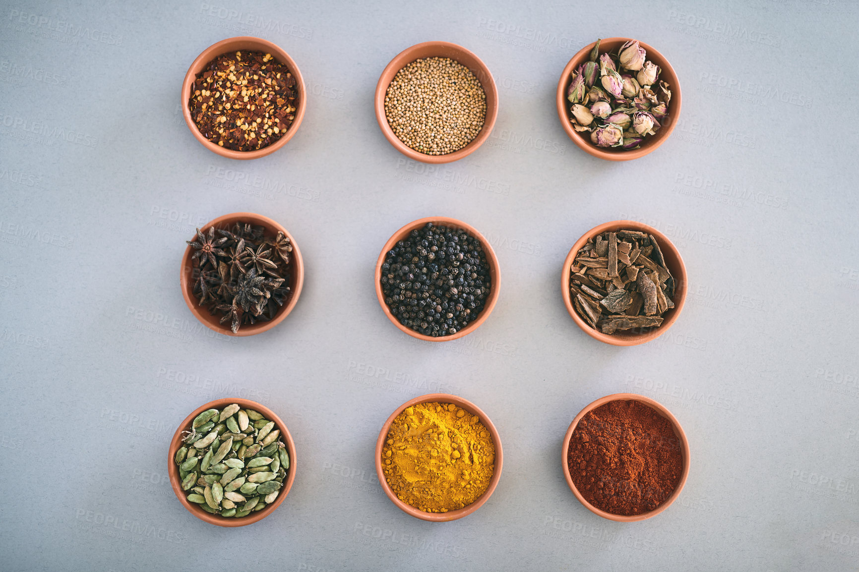 Buy stock photo Spices, bowl and variety of herbs seasoning on studio background for cooking and top view mockup. Selection, organic condiments and flavor ingredients with cinnamon, masala powder and ground pepper