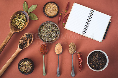 Buy stock photo Spices, ingredients and variety of herbs with notebook on studio background for cooking recipe and meal ideas. Utensils, organic seasoning and cookbook for condiments with curry powder and top view