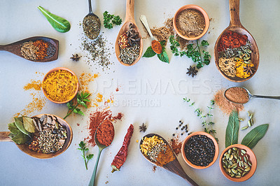 Buy stock photo Spices, ingredients and selection of fresh seasoning on studio background for cooking and top view. Utensils, organic condiments and herbs additives with curry leaves, masala powder and ground pepper