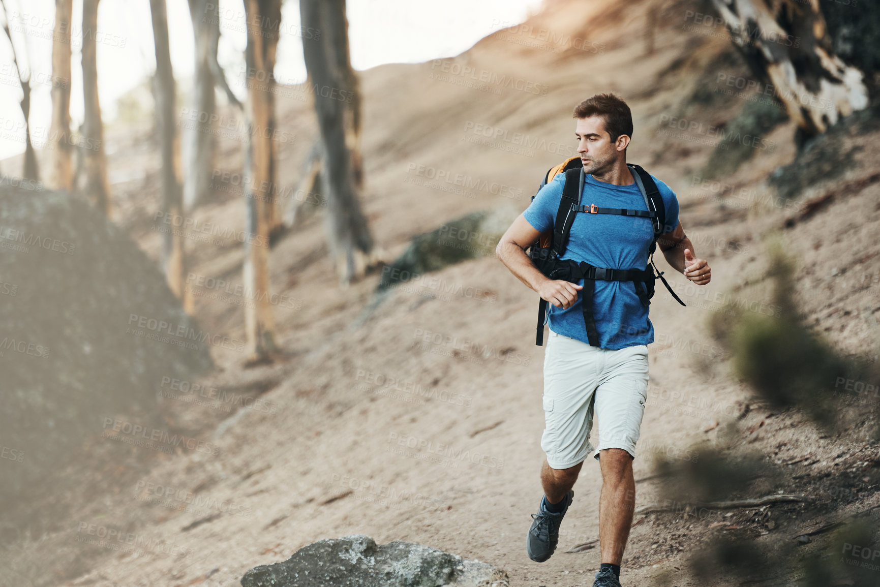 Buy stock photo Man, backpack and running in nature forest for wilderness experience, exploration and solitude for stress relief or survival. Guy, outdoor and hiking in woods for adventure or physical exercise.