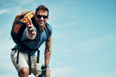 Buy stock photo Portrait of a cheerful young man stretching out his hand to help while going for a hike up a mountain