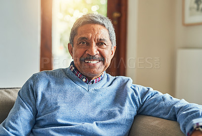 Buy stock photo Portrait of a handsome senior man relaxing on sofa at home