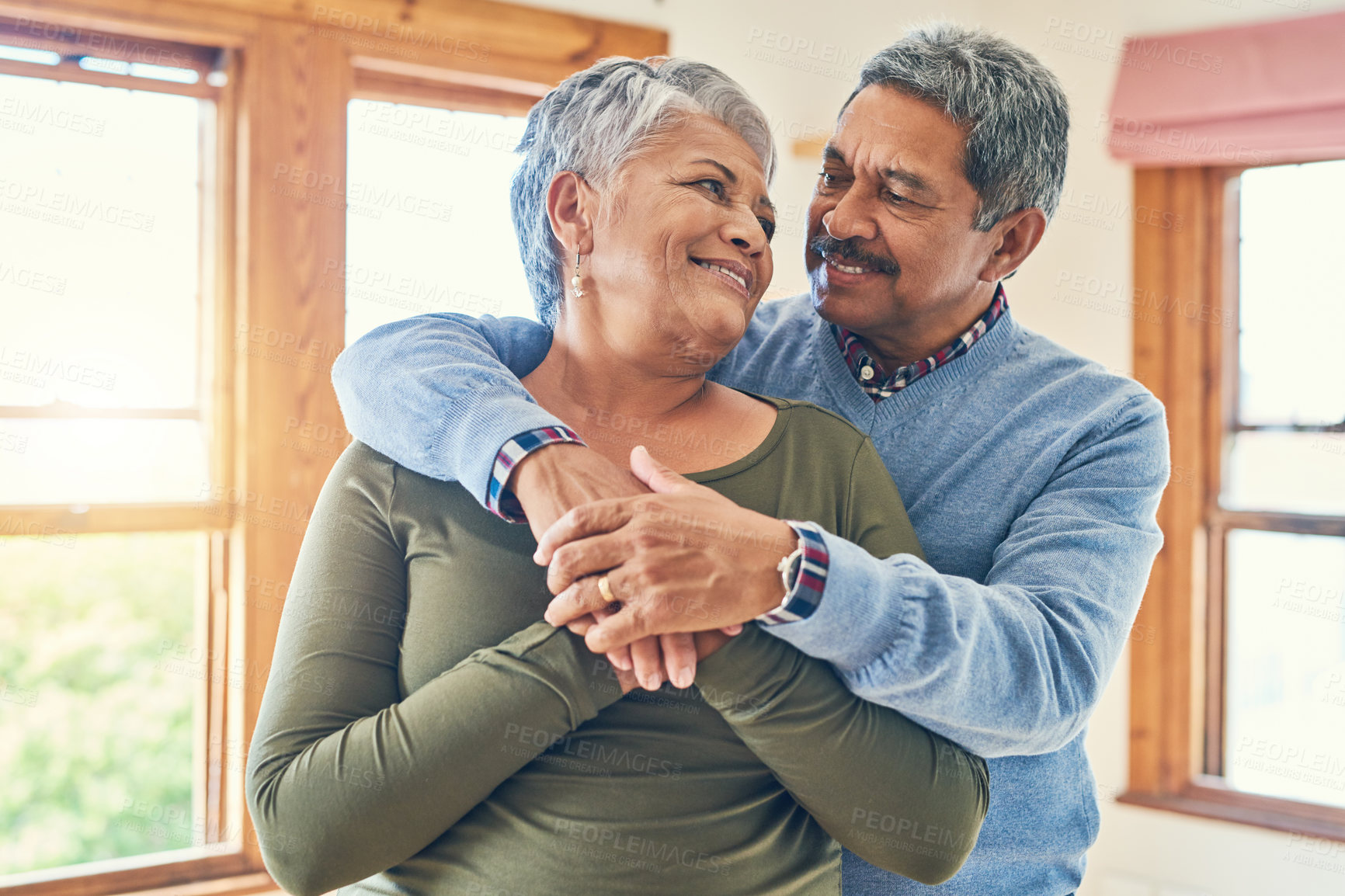Buy stock photo Shot of an affectionate senior couple posing together in their home