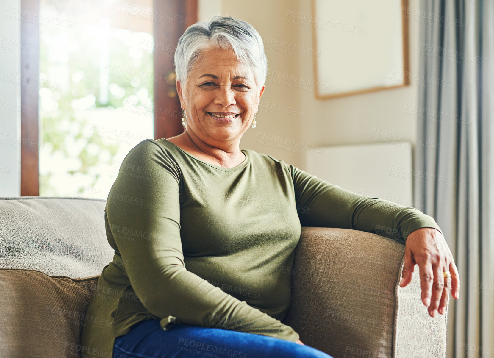 Buy stock photo Portrait of a senior woman relaxing on a sofa at home