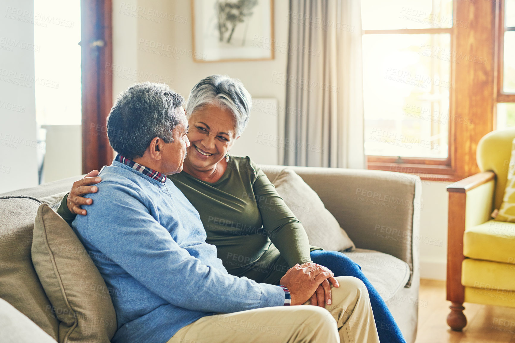 Buy stock photo Shot of an affectionate senior couple relaxing on a sofa together at home