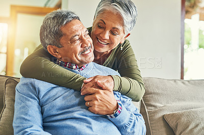 Buy stock photo Shot of an affectionate senior couple relaxing on a sofa together at home