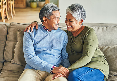 Buy stock photo Marriage, hug and elderly couple on sofa for love, wellness and proud for mortgage repayment. Senior man, happy woman and support at retirement home for insurance, financial security and milestone