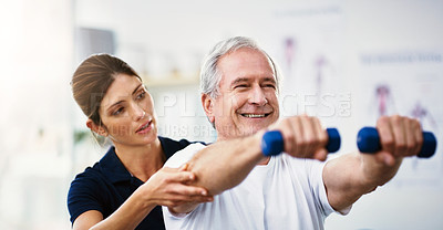Buy stock photo Physiotherapy, senior man and dumbbell exercise, injury rehabilitation or workout at health clinic. Happy elderly patient, woman physiotherapist or muscle training for strong body, care or fitness