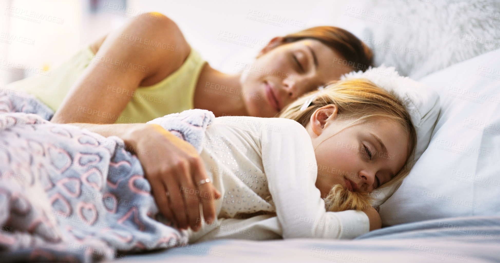Buy stock photo Relax, sleep and a mother in bed with her daughter in the morning while dreaming in their home together. Family, kids and a woman sleeping in the bedroom with her young female child for peaceful rest