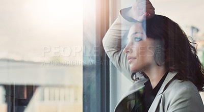 Buy stock photo Cropped shot of an attractive young businesswoman feeling depressed at work