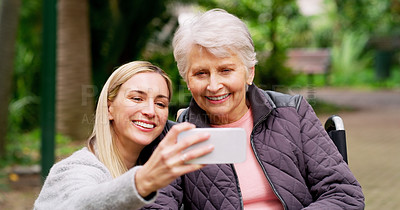 Buy stock photo Cropped shot of a cheerful elderly woman and her daughter taking a self portrait together outside in a park