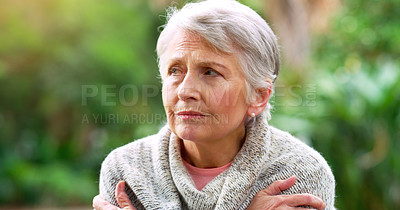 Buy stock photo Cropped shot of a carefree elderly woman seated on a bench while contemplating outside in a park